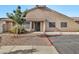 Tan two-story home with a red-trimmed driveway and small front yard at 3510 E Hampton Ave # 53, Mesa, AZ 85204