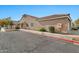 Tan home with a red-trimmed driveway and neatly landscaped side yard at 3510 E Hampton Ave # 53, Mesa, AZ 85204