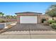 White garage door with a sloped roof, landscaping, and driveway at 3510 E Hampton Ave # 53, Mesa, AZ 85204