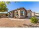 Tan house exterior with a two car garage and walkway at 42227 W Oakland Dr, Maricopa, AZ 85138