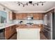 Modern kitchen with stainless steel appliances and wooden cabinetry at 42227 W Oakland Dr, Maricopa, AZ 85138