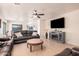 Spacious living room featuring leather reclining sofas, a coffee table, and a modern entertainment center at 42227 W Oakland Dr, Maricopa, AZ 85138