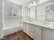 Elegant bathroom with double vanity, soaking tub, and updated fixtures at 4319 E Vaughn Ave, Gilbert, AZ 85234