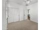 Bright bedroom with double door closet and carpet flooring at 4319 E Vaughn Ave, Gilbert, AZ 85234