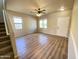 Bright living room with wood-look flooring, a ceiling fan, and access to the front door at 4565 E Loma Vista St, Gilbert, AZ 85295