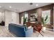 Modern living room with blue sofa and wood-look floors at 4810 E Helena Dr, Scottsdale, AZ 85254