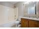 Bathroom with shower/tub combo and wood cabinets at 555 W Racine Loop, Casa Grande, AZ 85122