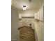 Bright laundry room with white cabinets and wood-look flooring at 6512 N Loma Ct, Casa Grande, AZ 85194