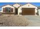 New construction home with a two-car garage and desert landscaping at 7280 E White Tail Rd, San Tan Valley, AZ 85143