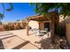 Relaxing patio with covered seating area, tile flooring, and built-in grill at 7825 E Granada Rd, Scottsdale, AZ 85257