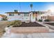 View of the home's back, showing a patio and landscaping at 1124 E Orchid Ln, Phoenix, AZ 85020