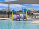 Community waterpark with spray features and shaded seating at 16066 W Prickly Pear Trl, Surprise, AZ 85387