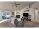 Comfortable living room with fireplace, TV, and large windows at 17101 E Malta Dr, Fountain Hills, AZ 85268