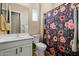 Clean bathroom with floral shower curtain and white vanity at 20619 W Grandview Dr, Buckeye, AZ 85396