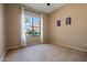 Simple bedroom with large window and neutral carpet at 20619 W Grandview Dr, Buckeye, AZ 85396