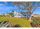 Side view of the house showing manicured lawn and landscaping at 2102 E Norwood St, Mesa, AZ 85213