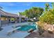 Inviting pool with diving board, surrounded by lush landscaping and a patio at 2102 E Norwood St, Mesa, AZ 85213