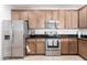 Modern kitchen with stainless steel appliances and wood cabinets at 2511 W Queen Creek Rd # 340, Chandler, AZ 85248