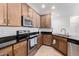 Modern kitchen with stainless steel appliances and wood cabinets at 2511 W Queen Creek Rd # 340, Chandler, AZ 85248