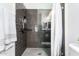 Walk-in shower with dark tile surround at 2511 W Queen Creek Rd # 340, Chandler, AZ 85248