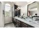 Elegant bathroom with double sinks, marble countertops, and large mirror at 3348 E Woodland Dr, Phoenix, AZ 85048