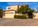 Tan two-story house with a two-car garage and nicely landscaped front yard at 3348 E Woodland Dr, Phoenix, AZ 85048