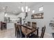 Elegant dining room features a wood table and access to kitchen at 41362 W Arvada Ln, Maricopa, AZ 85138