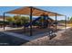 Covered playground with slides and climbing structures at 41362 W Arvada Ln, Maricopa, AZ 85138