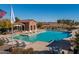 Community pool with lounge chairs and cabana at 41362 W Arvada Ln, Maricopa, AZ 85138