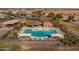 Community pool with lounge chairs and umbrellas at 41362 W Arvada Ln, Maricopa, AZ 85138