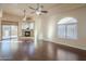 Bright living room with hardwood floors, fireplace, and ceiling fans at 4202 E Broadway Rd # 132, Mesa, AZ 85206