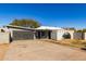 Front view of a ranch-style home with a dark gray garage door at 5302 N 22Nd Ave, Phoenix, AZ 85015