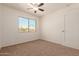 Bright bedroom with ceiling fan and window at 600 S Dobson Rd # 75, Mesa, AZ 85202