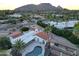 Aerial view showcasing home, pool, tennis court, and mountain views at 6740 E Valley Vista Ln, Paradise Valley, AZ 85253