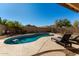 Kidney-shaped pool with lounge chairs in a sunny backyard at 6801 W Rowel Rd, Peoria, AZ 85383