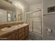 Bathroom boasts dual sinks, a shower, and wood cabinets at 8700 E University Dr # 545, Mesa, AZ 85207