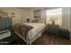 Bedroom with a queen-size bed and wood flooring at 8700 E University Dr # 545, Mesa, AZ 85207