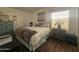 Cozy bedroom with a queen-size bed, dresser, and wood floors at 8700 E University Dr # 545, Mesa, AZ 85207