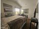 Main bedroom with a queen bed, stylish decor, and mirrored closet at 8700 E University Dr # 545, Mesa, AZ 85207
