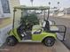 Side view of a green golf cart with white seats at 8700 E University Dr # 545, Mesa, AZ 85207