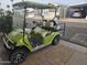 Front view of a green golf cart with white seats at 8700 E University Dr # 545, Mesa, AZ 85207