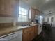 Kitchen features wood cabinets, double sink, and eat-in dining area at 8700 E University Dr # 545, Mesa, AZ 85207