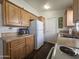 Kitchen with wood cabinets and white appliances at 8700 E University Dr # 545, Mesa, AZ 85207