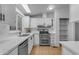 Modern kitchen with white cabinets and stainless steel appliances at 9030 E Ebola Ave, Mesa, AZ 85208