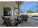 Relaxing patio with wicker furniture, offering a view of the pool and backyard at 9512 E Altadena Ave, Scottsdale, AZ 85260