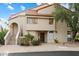 Tan stucco condo building with tile roof, landscaping, and stairs leading to the entrance at 9707 E Mountain View Rd # 2448, Scottsdale, AZ 85258