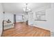 Bright dining room with hardwood floors and kitchen pass-through at 11121 W Mirandy Ct, Sun City, AZ 85351