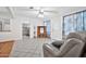 Bright living room features tile floors and a view into the kitchen at 11121 W Mirandy Ct, Sun City, AZ 85351