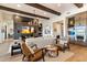 Living room with wood beams, fireplace, and views into kitchen and dining areas at 13126 E La Junta Rd, Scottsdale, AZ 85255