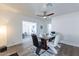 Modern dining room with glass table and four chairs, open to living room at 1322 W Flower St, Phoenix, AZ 85013